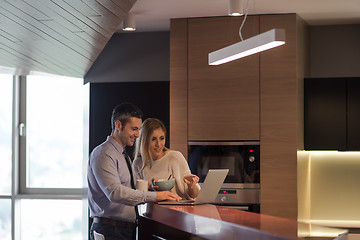 Image showing A young couple is preparing for a job and using a laptop