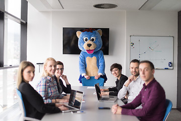 Image showing boss dresed as bear having fun with business people in trendy of