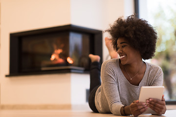 Image showing black women using tablet computer on the floor