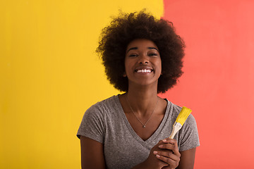 Image showing black woman painting wall