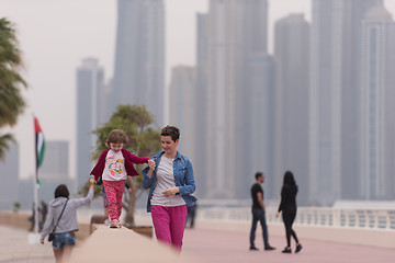 Image showing mother and cute little girl on the promenade