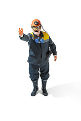 Image showing The studio shot of senior bearded male miner standing at the camera on a white background.