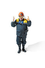 Image showing The studio shot of senior bearded male miner standing at the camera on a white background.