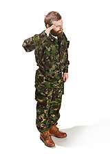 Image showing Young army soldier wearing camouflage uniform isolated on white