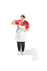 Image showing Portrait of cute smiling woman with bowl in her hands in the studio, isolated on white background