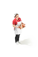 Image showing Portrait of cute smiling woman with pastries in her hands in the studio, isolated on white background