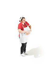 Image showing Portrait of cute smiling woman with bowl in her hands in the studio, isolated on white background