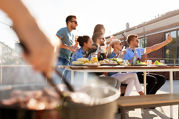 Image showing happy friends taking selfie at rooftop party