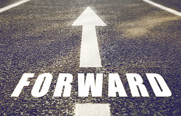 Image showing close up of arrow and word forward on asphalt road