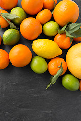 Image showing close up of citrus fruits on stone table