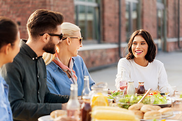 Image showing friends having dinner or bbq party on rooftop