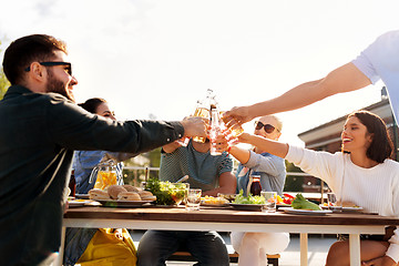 Image showing happy friends toasting drinks at rooftop party