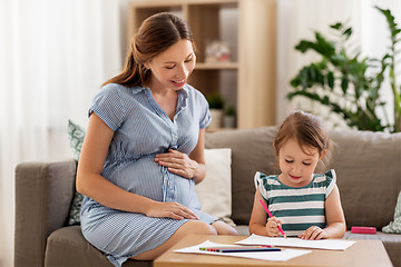 Image showing pregnant mother and daughter drawing at home