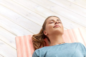 Image showing woman doing yoga corpse pose at studio