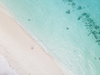 Image showing Aerial shot of woman enjoying the picture perfect white tropica beach on Mauritius island.