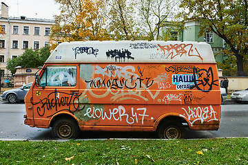 Image showing Old broken orange van completely riddled with graffiti