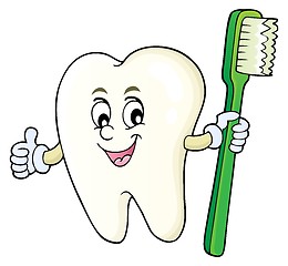 Image showing Tooth holding toothbrush theme image 1