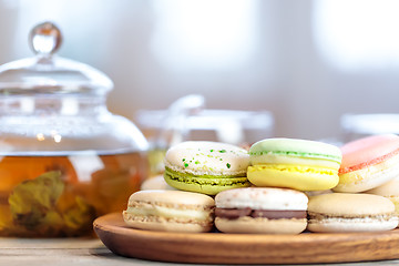 Image showing Close-up of colorful macaron (macaroon) on the table with hot te