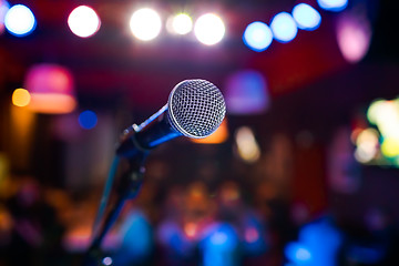 Image showing Microphone on stage against a background of auditorium.