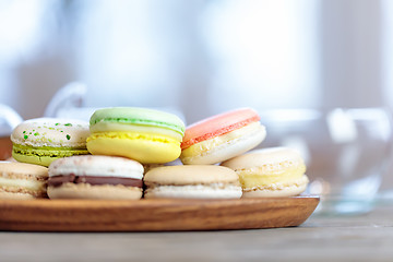 Image showing Close-up of colorful macaron (macaroon) on the table with hot te