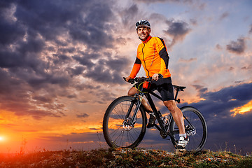 Image showing Man in helmet and glasses stay on the bicycle