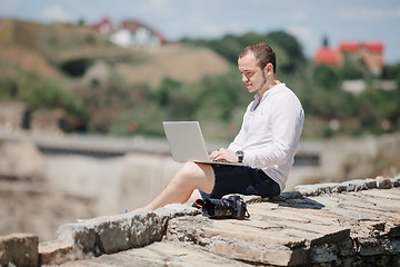 Image showing Man using a modern portable computer on the park