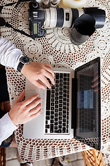 Image showing man working with laptop computer and sitting on sofa