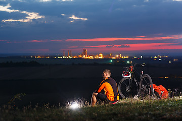 Image showing guy has a rest sitting near his bike