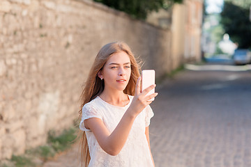 Image showing Girl take selfie from hands with phone on summer city