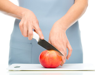 Image showing Cook is chopping apple