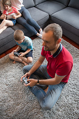 Image showing Happy family playing a video game