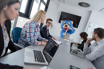 Image showing boss dresed as bear having fun with business people in trendy of