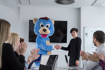 Image showing boss dresed as bear having fun with business people in trendy of