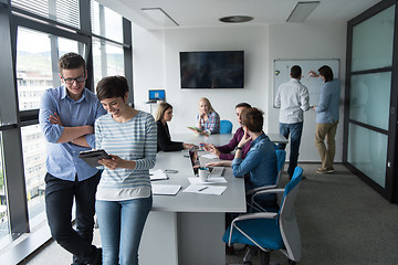 Image showing Two Business People Working With Tablet in office