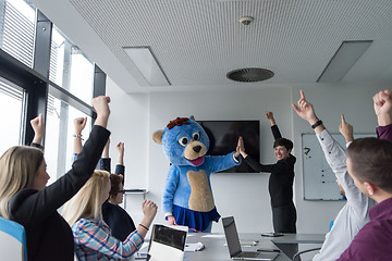 Image showing boss dresed as bear having fun with business people in trendy of