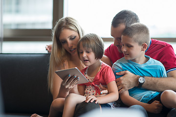 Image showing happy young couple spending time with kids