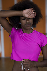 Image showing afro american woman running on a treadmill