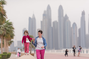 Image showing mother and cute little girl on the promenade