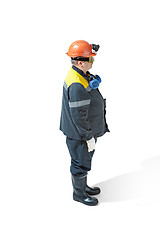 Image showing The studio shot of senior bearded male miner standing at the camera on a white background.