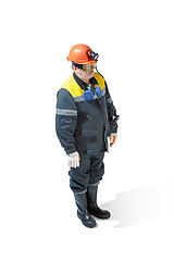 Image showing The studio shot of senior bearded male miner standing at the camera on a white background.