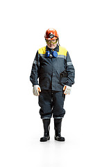 Image showing The studio shot of sad senior bearded male miner standing at the camera on a white background.