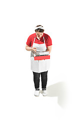 Image showing Portrait of cute smiling woman with laptop in her hands in the studio, isolated on white background