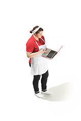 Image showing Portrait of cute smiling woman with laptop in her hands in the studio, isolated on white background