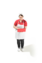 Image showing Portrait of cute smiling woman with laptop in her hands in the studio, isolated on white background