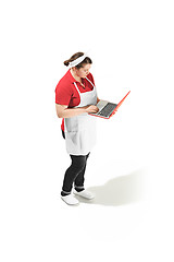 Image showing Portrait of cute smiling woman with laptop in her hands in the studio, isolated on white background