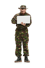 Image showing Young army soldier wearing camouflage uniform isolated on white