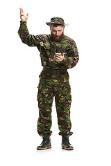 Image showing Young army soldier wearing camouflage uniform isolated on white