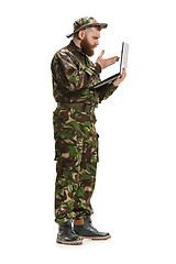 Image showing Young army soldier wearing camouflage uniform isolated on white