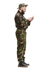 Image showing Young army soldier wearing camouflage uniform isolated on white