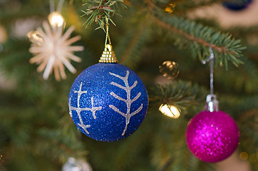 Image showing Two decorative balls on christmas tree branch.